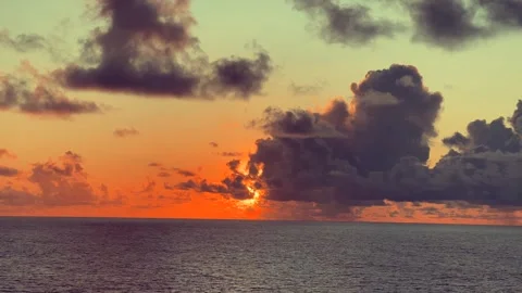 Sunset over the ocean with dramatic clouds in the sky creating a serene and.. Stock Footage 338282199