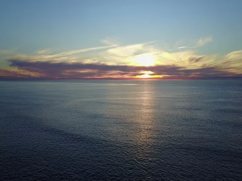 Sunset over ocean with drone - pan to the right 4K 스톡 동영상 71164243