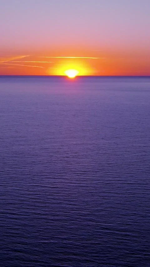 Sunset Over the Ocean During Twilight With Orange and Purple Colors on the Stock Footage 322937689