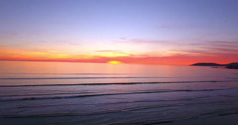 Sunset over ocean. Fly up and away from Horizon. 4k Aerial Stock Footage 145221915