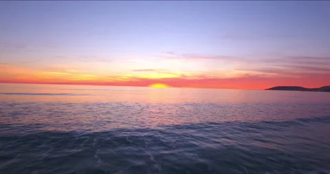 Sunset Over Ocean. Fly low over ocean and Away From Horizon. 4K Aerial Stock Footage 145176204