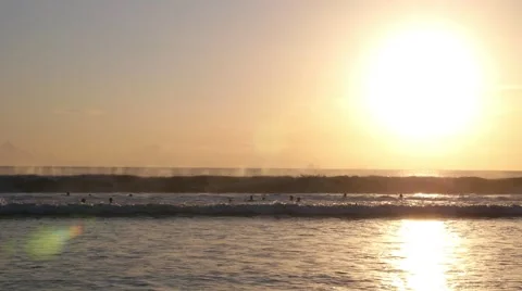 Sunset Over Ocean with Foamy Waves and Surfers on Bali Stock Footage 65267178
