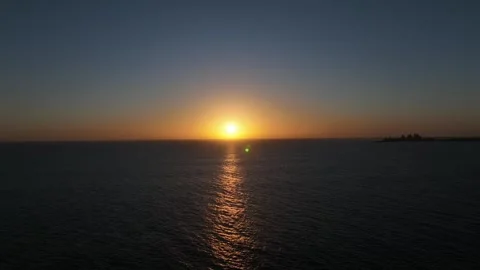 Sunset Over Ocean with Gentle Breeze and Distant Pier – Gran Canaria Aerial Stock Footage 309940472