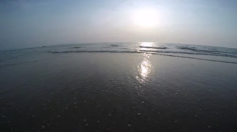Sunset Over the Ocean with Gentle Waves Using a Wide Fisheye Lens - 4K. Stock Footage 46188491
