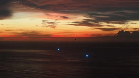 Sunset over ocean with illuminated buoys and colorful sky reflections Stock-Footage 337419079
