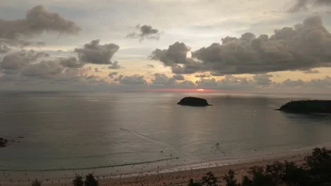 Sunset over ocean with island view and clouds reflecting warm colors Vídeos de archivo 342332162