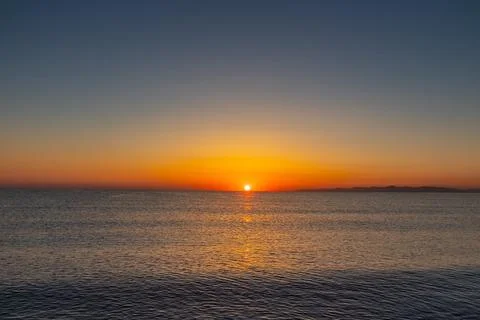 Sunset over the Ocean with Mountains in the Background, Tunisia Stock Photos