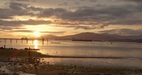 Sunset over the Ocean with Mountains Video stock 129860376