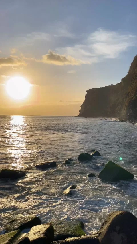 Sunset over the ocean near the mountains on Madeira Island. Vertical video Stock Footage 332716041