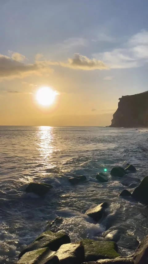 Sunset over the ocean near the mountains on Madeira Island, Vertical video Stock Footage 332716044