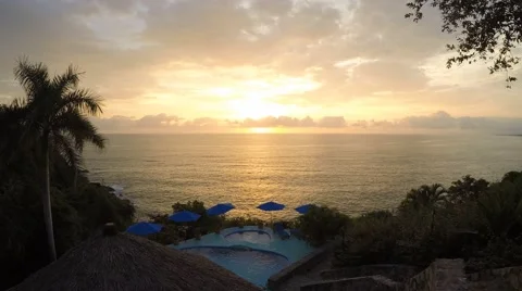 Sunset over the ocean with pool and umbrellas Stock Footage 43120483