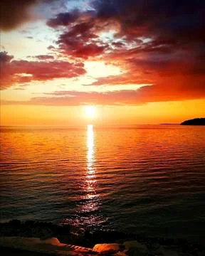 Sunset over the ocean in summer Stock Photos