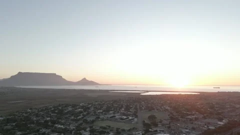 Sunset over the ocean with Table Mountain in the background Stock Footage 317994370
