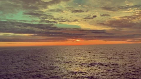 Sunset over the ocean with vibrant colors in the sky and peaceful waves ref.. Stock Footage 338279793