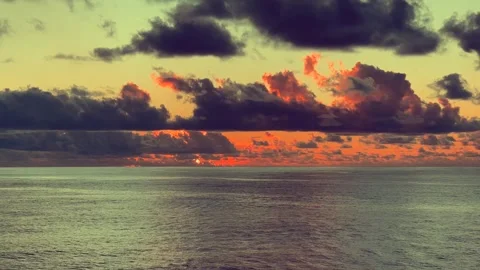 Sunset over the ocean with vibrant colors illuminating the sky and dark clo.. Stock Footage 338281817