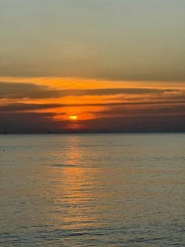 Sunset over Ocean with Warm Reflections Stock Photos