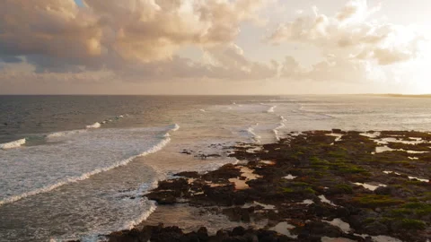 Sunset over ocean with wave breaks and rocky shoreline in Yucatan peninsula Stock Footage 321527144