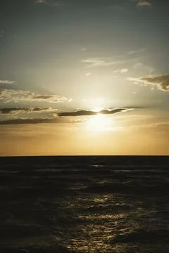 Sunset Over Ocean Waves Captured at Dusk Stock Photos