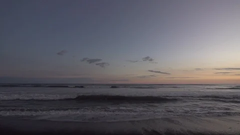 Sunset Over Ocean With Waves Lapping Shot in Slow Motion Stock Footage 87723843