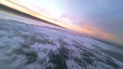 Sunset over ocean, waves rolling in with soft colors Stock Footage 344542669