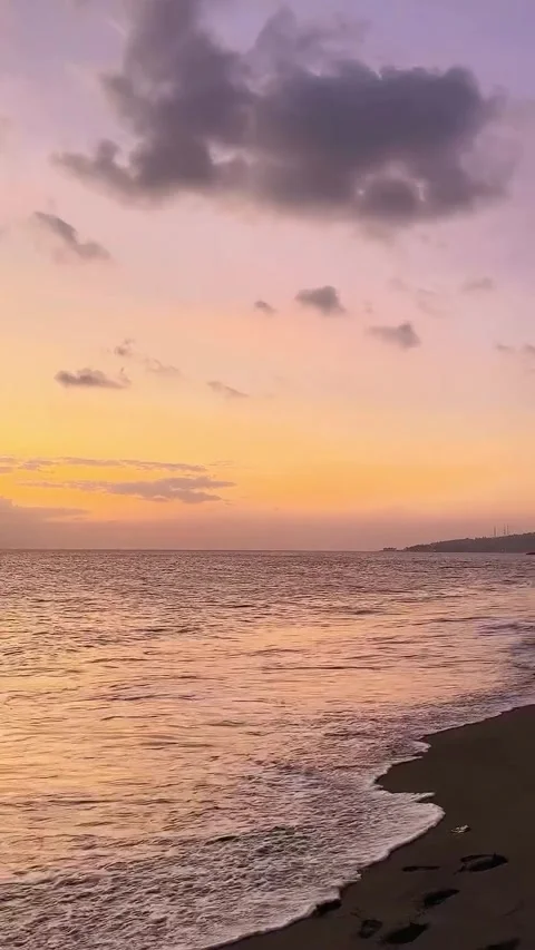 Sunset over Ocean Waves on Sandy Beach Video stock 340563952
