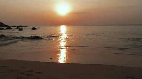 Sunset over ocean with waves on shore Video stock 56444221