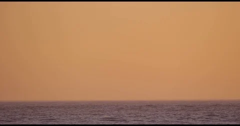 Sunset over ocean waves shot on red Stock Footage 127120632