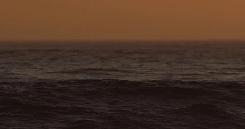 Sunset over ocean waves shot on red Stock Footage 127120963