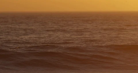 Sunset over ocean waves shot on red Stock Footage 127121123