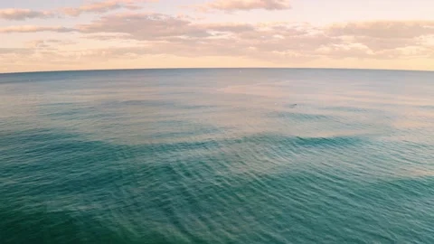 Sunset over ocean waves wash sand beach. Stock Footage 205611722