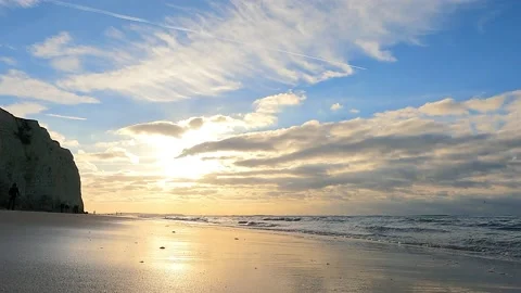 Sunset over ocean waves wash sand beach. Aerial sun set above mountain Stock Footage 219551594