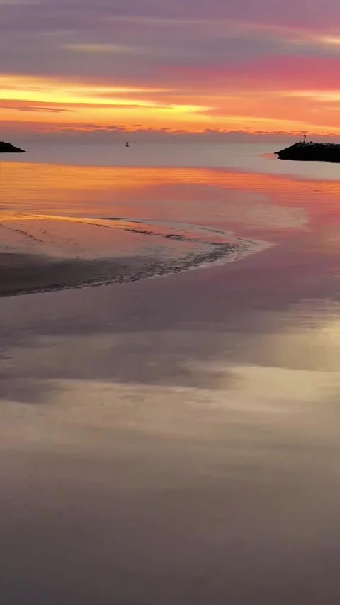 Sunset over ocean waves wash sand beach. Stock Footage 234295611