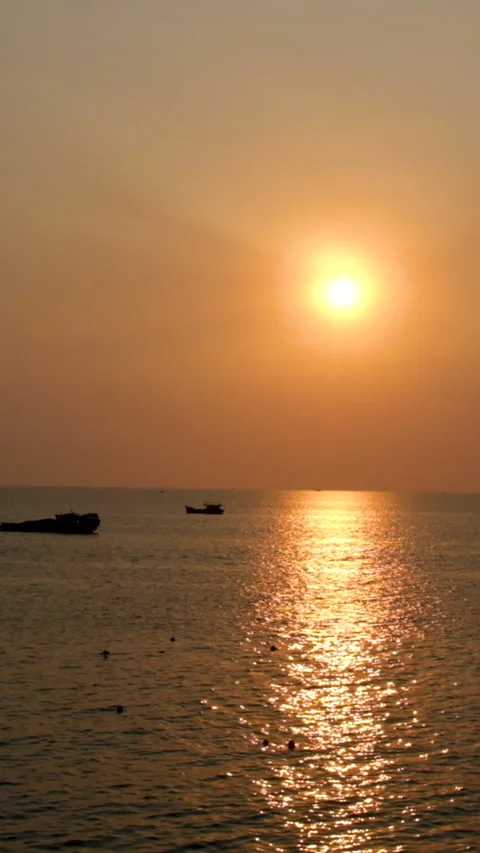 Sunset over ocean waves wash sand beach. Aerial sun set above mountain Stock Footage 307088813