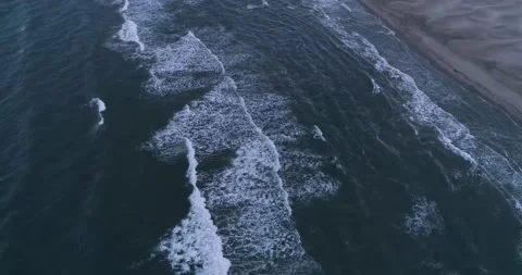 Sunset over ocean waves washes sand beach. The aerial sun set above the sea Stock Footage 201059965