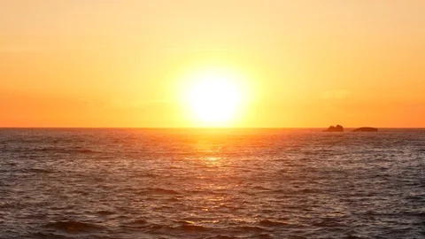 Sunset over the ocean, zoom out from sun to wide angle. Stock Footage 107995366