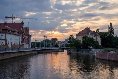 A sunset over Odra river, viewed from Piaskowy Bridge, Wroclaw, Poland. Stock Photos