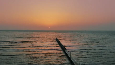 Sunset over Okamoto Pier as Camera Gently Pans at Haraoka Beach Stock Footage 342266201