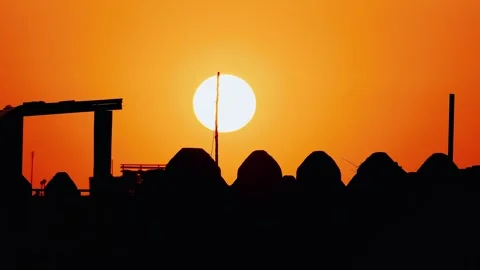 Sunset over old Middle Eastern town in summer. Sun setting against the backdrop Stock Footage 271348570