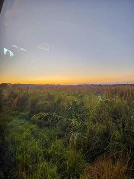 Sunset over open field Stock Photos