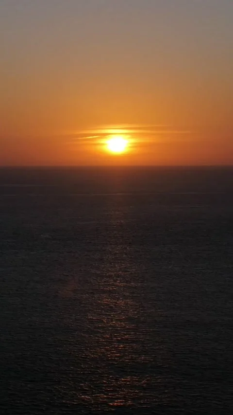 Sunset Over Open Ocean With Shimmering Reflection On Waves, Long Shot Of Sun 스톡 동영상 333775293