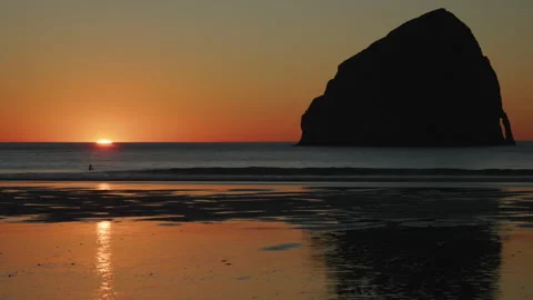 Sunset over Pacific Ocean with sea stack silhouette Oregon Coast 스톡 동영상 327419056