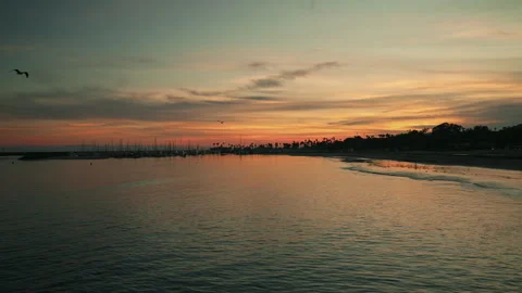 Sunset over the Pacific Ocean showing the sailing boats and the beach Stock Footage 341662323