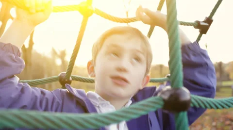 Sunset over park as a young child plays Stock Footage 32960314
