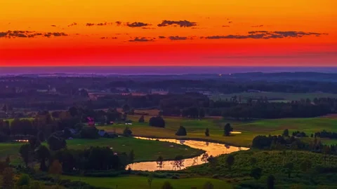 Sunset over patchwork farmland and winding country roads with reflections Video stock 315265719