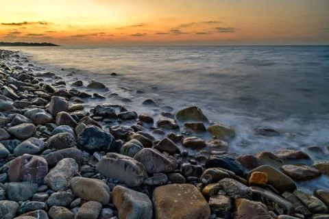 Sunset over pebble beach Stock Photos
