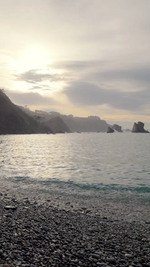 Sunset Over Pebble Beach with Rocky Cliffs at Silence Beach, Asturias, Spain Video stock 302297205