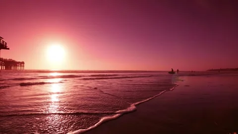 Sunset over a pier with reflections on the water in 4K Stock Footage 283461997