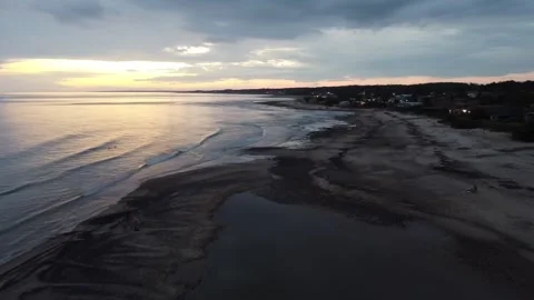 Sunset over Piriápolis beach, Uruguay, with calm waters reflecting evening sky. Stock Footage 304191848