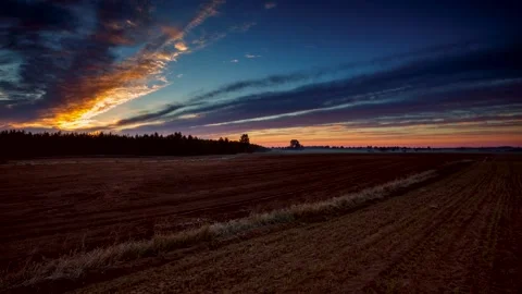 Sunset over plowed field at early winter, 4k time lapse. Video stock 154529029