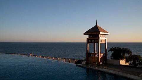 Sunset over the pool overlooking the sea Stock Footage 326779394